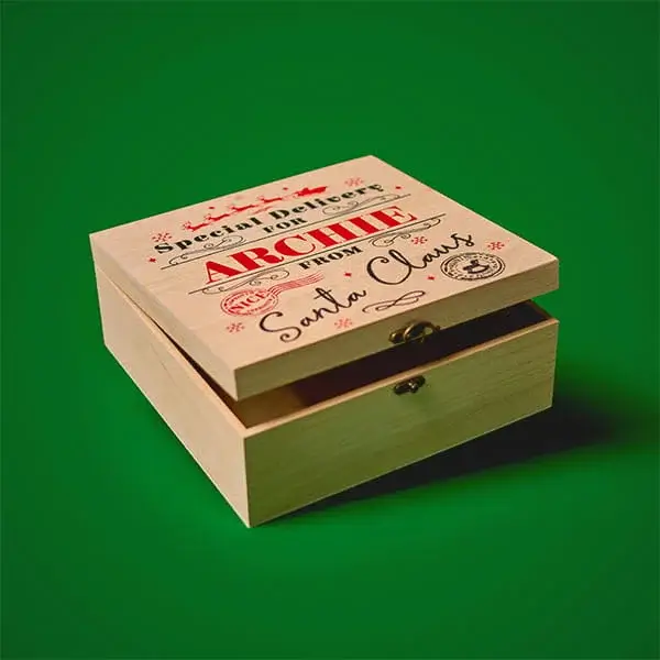 Personalised wooden Christmas Eve box with festive typography and Santa Claus postmark-style design on the lid.
